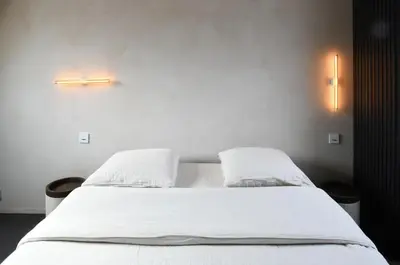 a bedroom with a white bed with two pillows at B&B deZwarteFles in Ghent