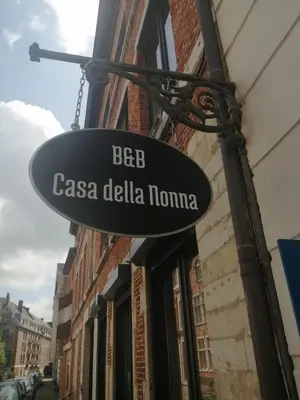 a sign hanging from the side of a building at Casa della Nonna in Diest