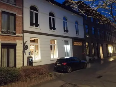 a car parked in front of a white building at Casa della Nonna in Diest