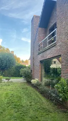 a brick building with a balcony on the side of it at Efes home in Ghent