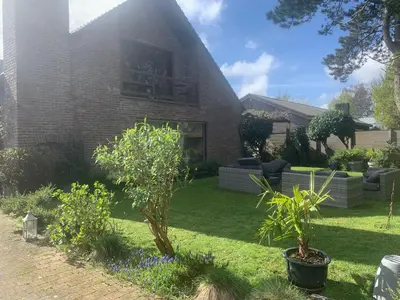 a house with a yard with trees and plants at Efes home in Ghent