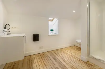 a bathroom with a shower and a sink and a toilet at The 1894 Boutique Holiday Apartment in Antwerp
