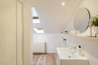 a bathroom with a sink and a mirror at The 1894 Boutique Holiday Apartment in Antwerp