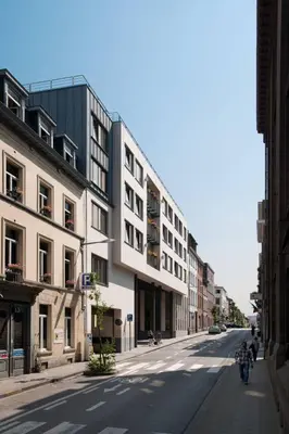 an empty street in a city with buildings at Youth Hostel van Gogh in Brussels