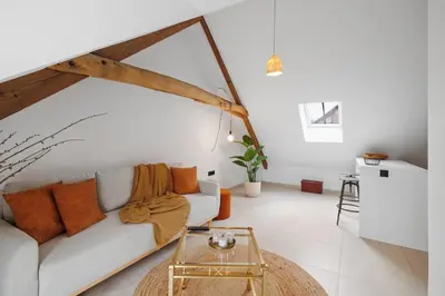 a living room with a couch and a table at The barn - Waasmunster in Waasmunster