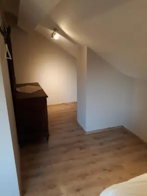an attic room with a bed and a desk at Wenceslas Cobergher IV in Bertem