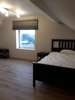 a bedroom with a bed and a large window at Wenceslas Cobergher IV in Bertem