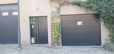 a pair of garage doors on a house at LodgeRivierenhof in Antwerp