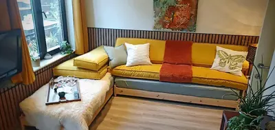 a couch with pillows on it in a room at LodgeRivierenhof in Antwerp