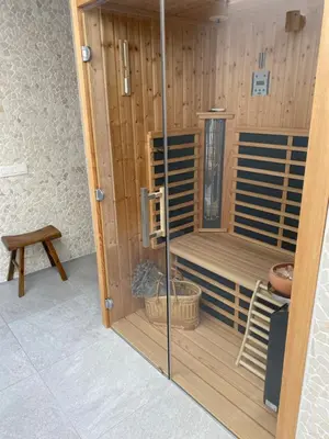 a room with a sauna with a bench and a stool at Miranius Rey in Lede