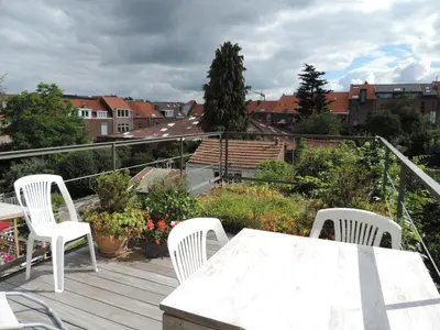 a white table and chairs on a deck with a view at B&B Lodging At 8 in Leuven