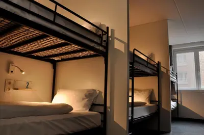 two bunk beds in a room with a window at The ASH in Antwerp