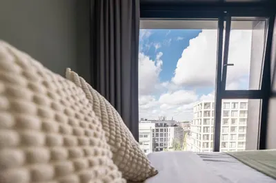 a bedroom with a window with a view of a city at The ASH in Antwerp
