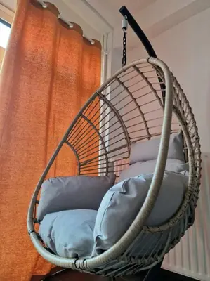 a hanging basket with pillows in front of a window at Hakuna Matata @ Opera in Antwerp