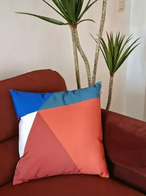 a colorful pillow on a couch with two palm trees at Hakuna Matata @ Opera in Antwerp
