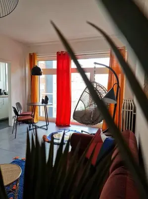 a living room with a red curtain and a table at Hakuna Matata @ Opera in Antwerp