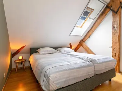 a bedroom with a large bed with two pillows at Alverwege 2 in Merksplas