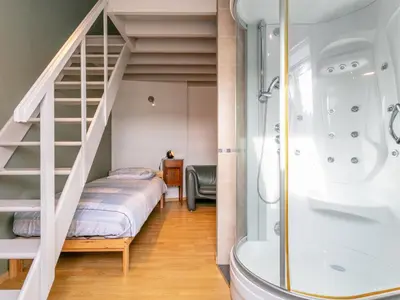 a bedroom with a bunk bed and a shower at Alverwege 2 in Merksplas