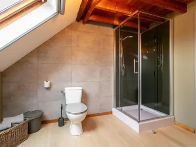 a bathroom with a toilet and a glass shower at Alverwege 2 in Merksplas
