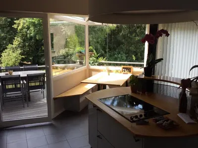 a kitchen with a balcony with a view of a table at B&B Uccle in Brussels