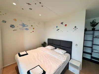 a bedroom with a bed with planets on the wall at Sky loft - Luxurious Penthouse - Antwerp 180 m² in Antwerp
