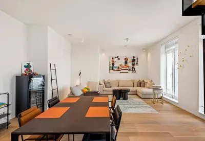 a living room with a table and a couch at Sky loft - Luxurious Penthouse - Antwerp 180 m² in Antwerp
