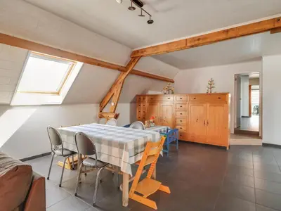 a dining room with a table and chairs at In de Wollekjes in Merksplas