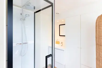 a bathroom with a shower with a glass door at Guesthouse private studio nearby old town Ghent in Ghent