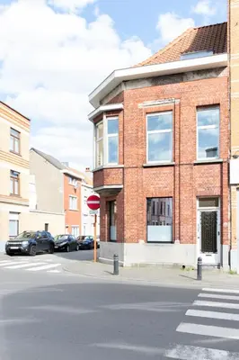a stop sign in front of a brick building at Guesthouse private studio nearby old town Ghent in Ghent