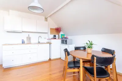 a kitchen and dining room with a table and chairs at Guesthouse private studio nearby old town Ghent in Ghent