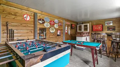 a room with a pool table and signs on the wall at An's Vakantiehuisje in Dessel