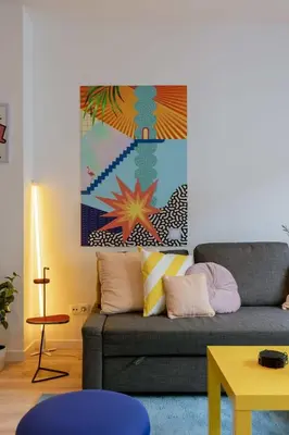 a living room with a couch and a painting on the wall at Colorful POP apartment in the heart of Antwerp in Antwerp
