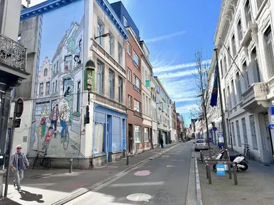 a city street with a mural on the side of a building at Colorful POP apartment in the heart of Antwerp in Antwerp