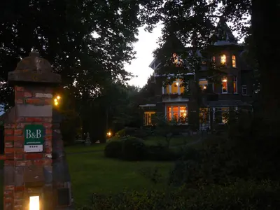 a large house with a sign in front of it at B&B Villa Emma in Ghent