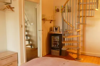 a spiral staircase in a room with a kitchen at B&B Villa Emma in Ghent