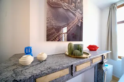 a table in a room with a painting on the wall at Easy Stay - City Center in Brussels
