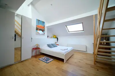 a white bedroom with a bed and a window at Easy Stay - City Center in Brussels