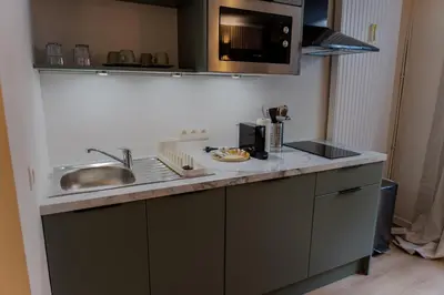 a kitchen counter with a sink and a microwave at Easy Stay - City Center in Brussels