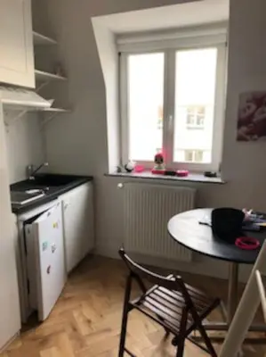 a small kitchen with a table and a window at Stay in maison de metre in Etterbeek in Brussels