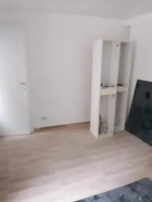 an empty room with white walls and a wooden floor at Stay in maison de metre in Etterbeek in Brussels