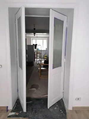 an open door into a living room with a room with a table at Stay in maison de metre in Etterbeek in Brussels