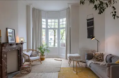 a living room with a couch and a fireplace at Bohemian city loft in Ghent