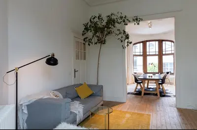 a living room with a couch and a table at Bohemian city loft in Ghent