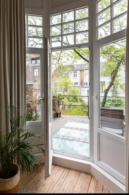 an open door with a view of a patio at Bohemian city loft in Ghent