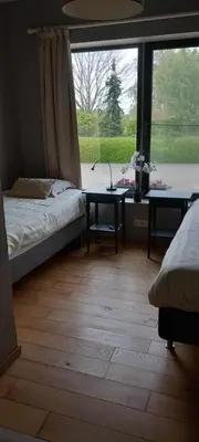 a room with a bed and a table and a window at Wenceslas Cobergher II Appartementen 2 of 4 in Boutersem