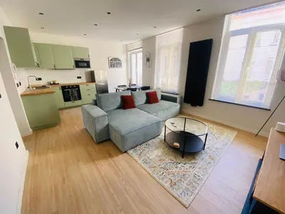 a living room with a couch and a table at Camus Flats in Brussels
