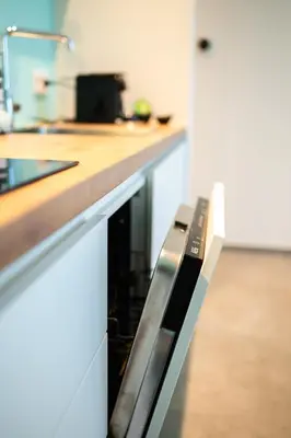a kitchen with a counter with a dishwasher at SYBA Gastenverblijf in Evergem