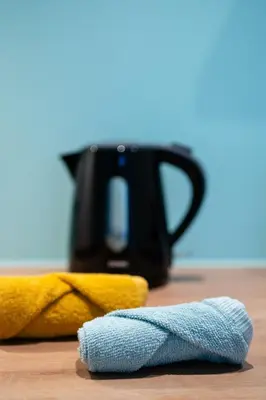 a close up of a towel and a coffee pot at SYBA Gastenverblijf in Evergem