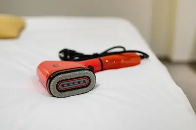 a red flashlight sitting on top of a bed at SYBA Gastenverblijf in Evergem