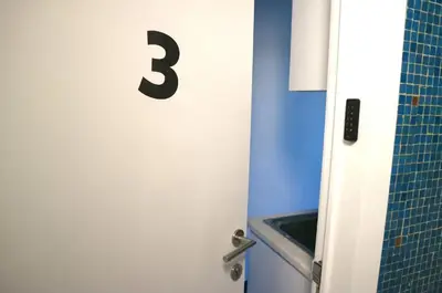 a door with the number three on it in a bathroom at Urban Cityflats - Center Antwerp in Antwerp
